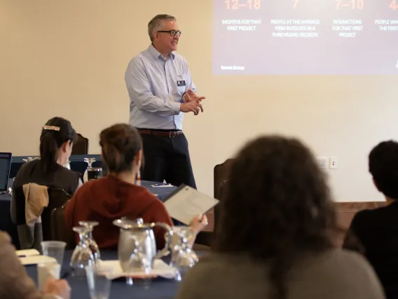 gray-haired man giving talk